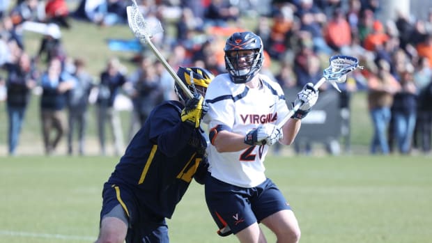 Griffin Schutz dodges with the ball during the Virginia men's lacrosse game against Michigan at Klockner Stadium.
